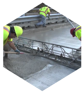 Workers using latex-modified concrete on a project